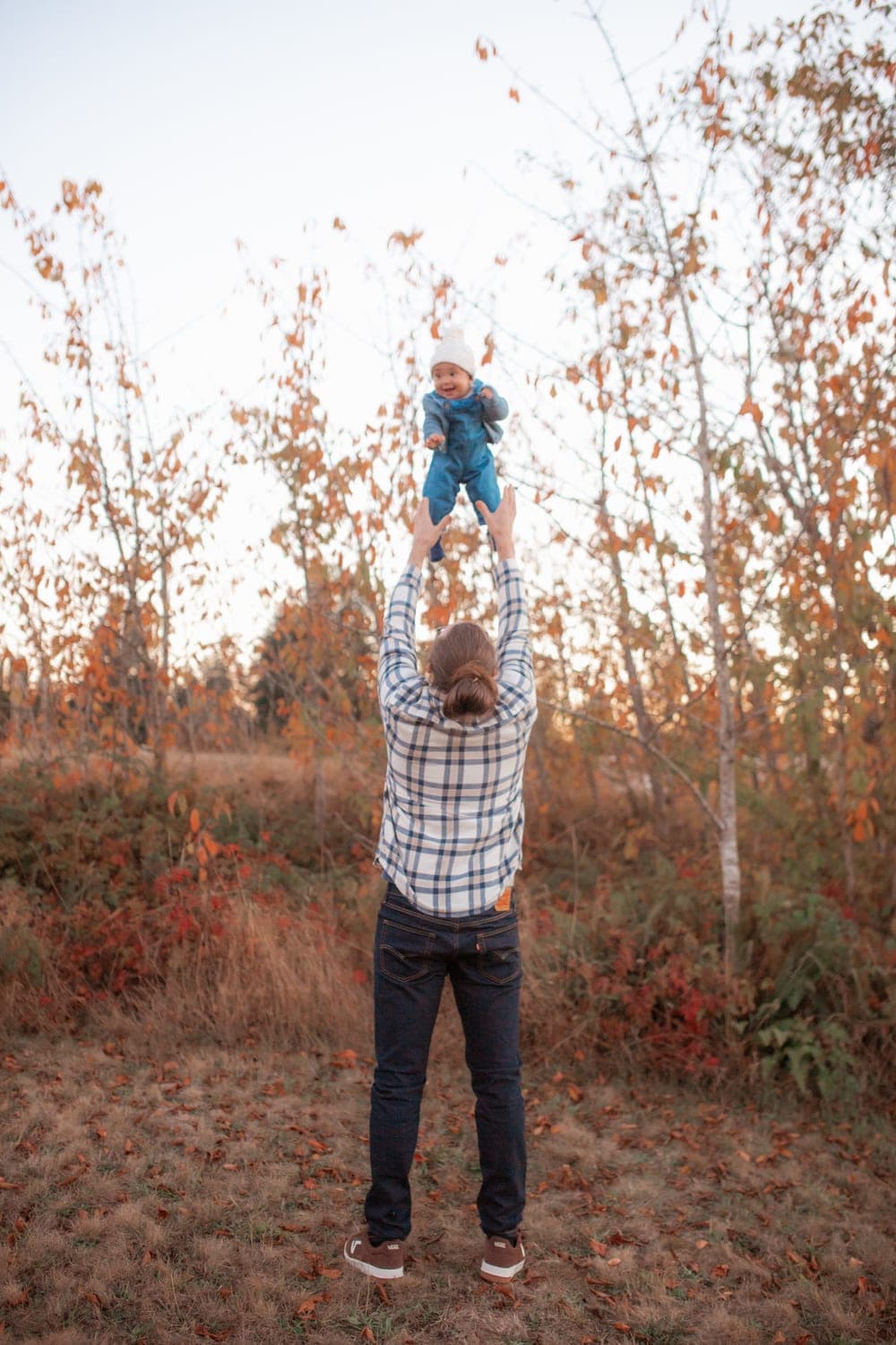 Dom lifting his daughter at golden hour